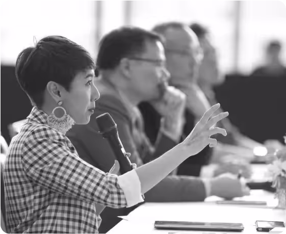 Amp as a mentor holds a microphone trying to explain something to the student